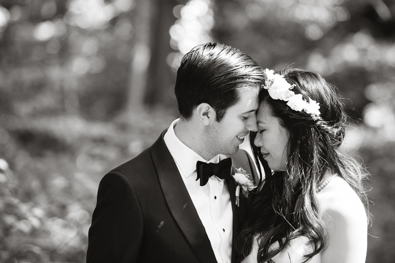 Black and white portrait of the bride and groom before their outdoor wedding ceremony.