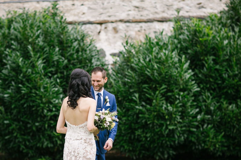 Bride and groom share their first look outside the barn at Grace Winery.