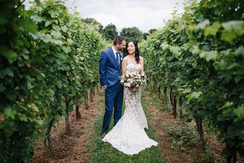 Bride and groom share a moment on the grounds at Grace Winery.