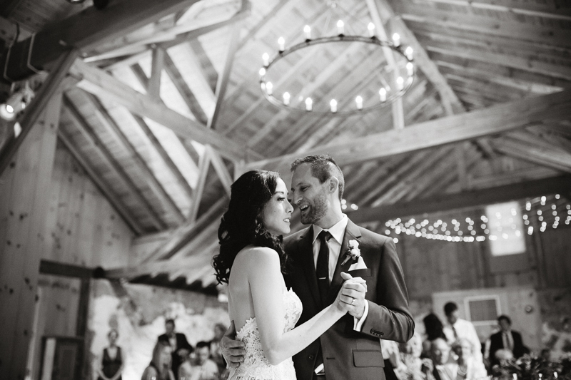 Black and white portrait of the bride and groom during their first dance.