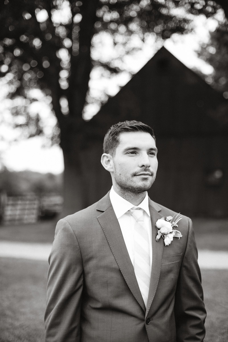 Black and white portraits of the groom for this outdoor barn wedding.
