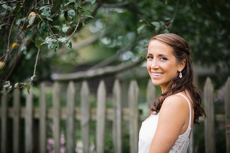 Bride poses for a photo before her outdoor wedding ceremony.