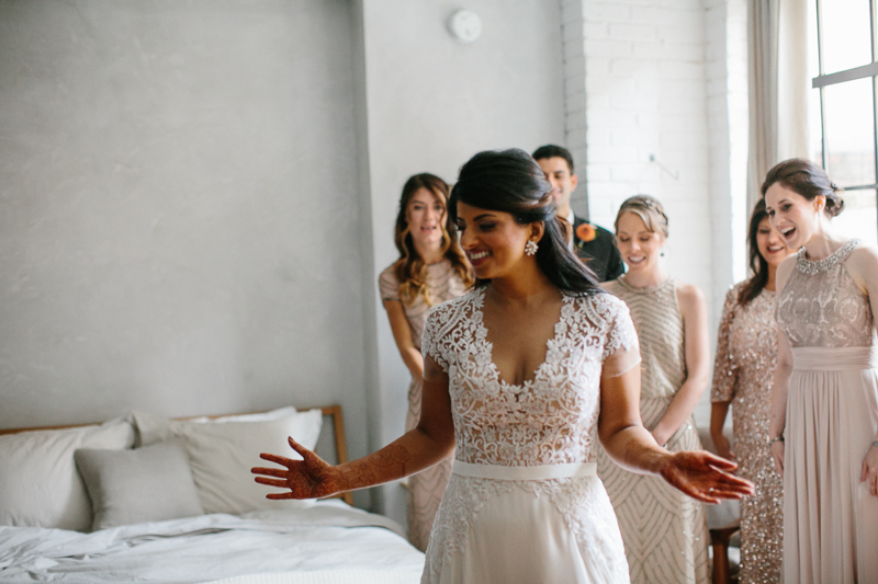 Bride puts on her modern dress at the unique Lokal hotel in Old City, Philadelphia.