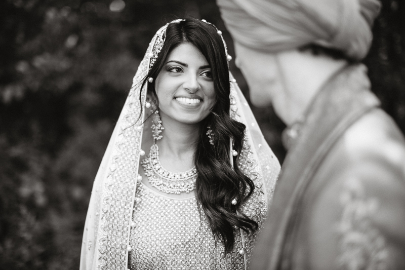 Black and white portrait of the bride after their outdoor Indian wedding ceremony.