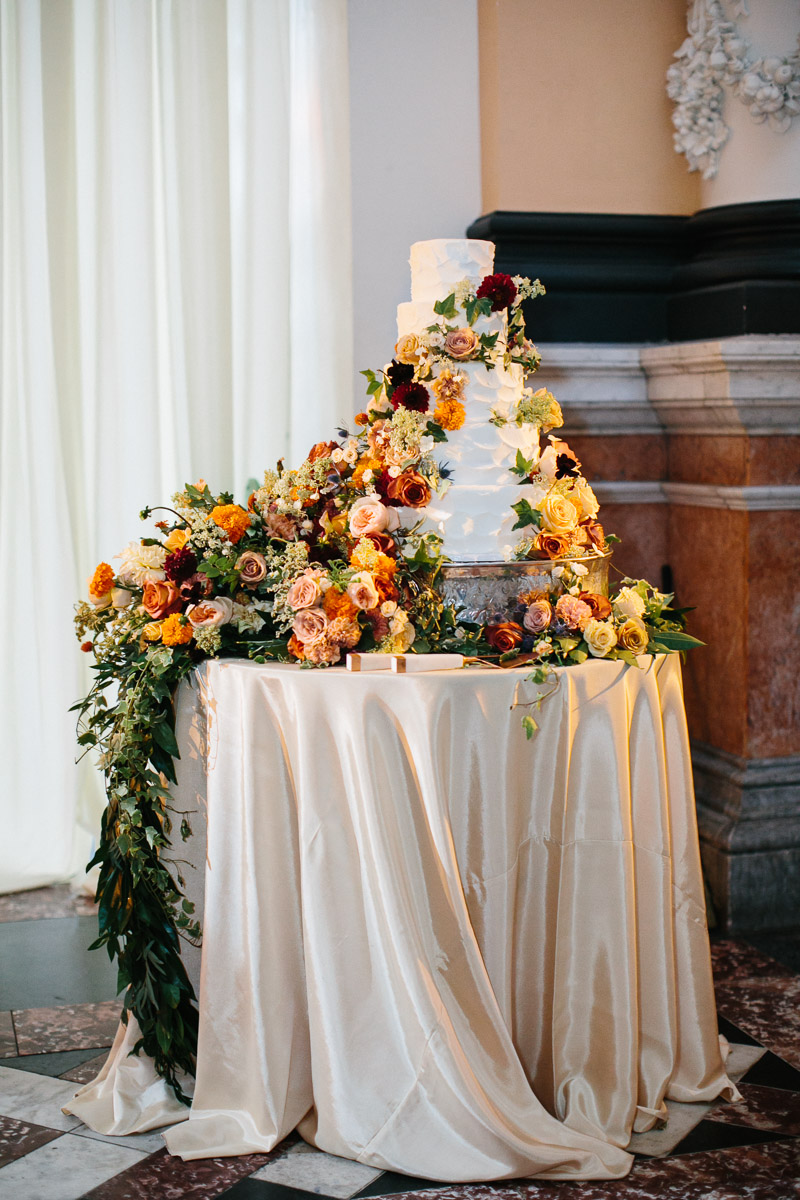 Gorgeous orange fall florals decorate the cake at the Please Touch Museum.