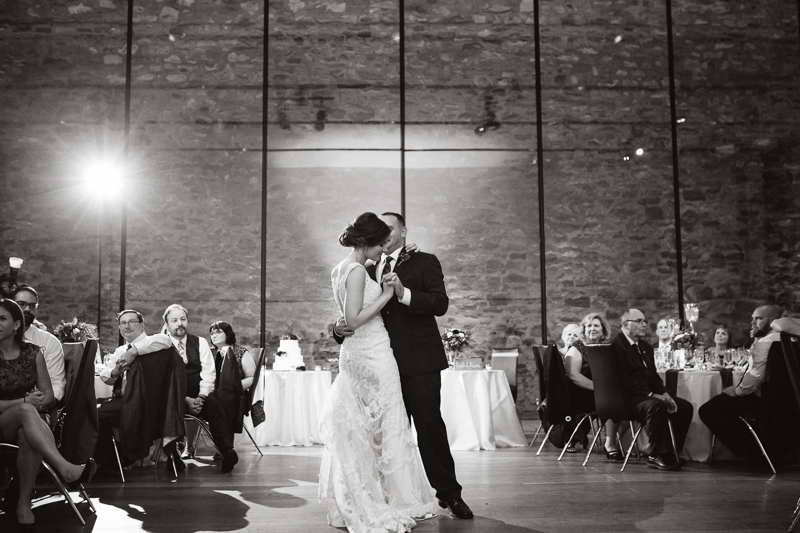 Unique black and white candid of the bride and groom during their first dance.
