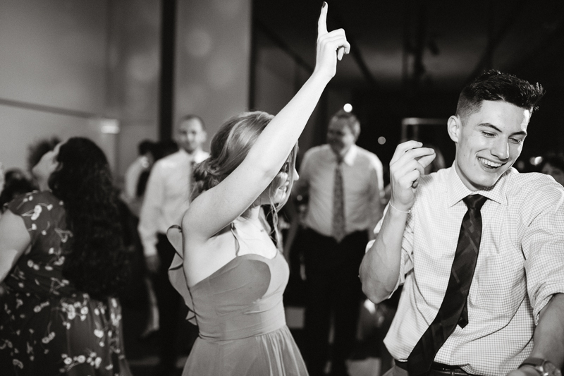 Black and white candids of guests dancing during this creative, modern wedding reception.