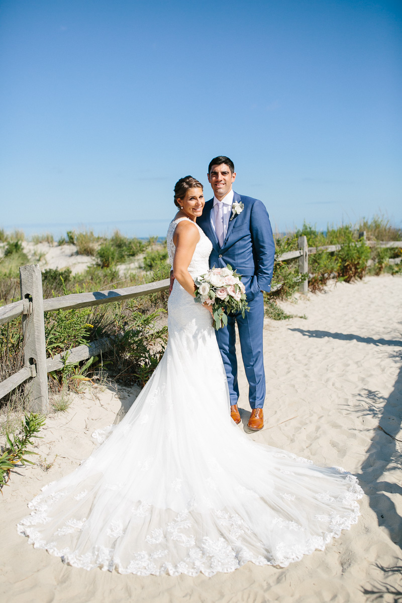 Modern portraits of the bride and groom down at the shore.
