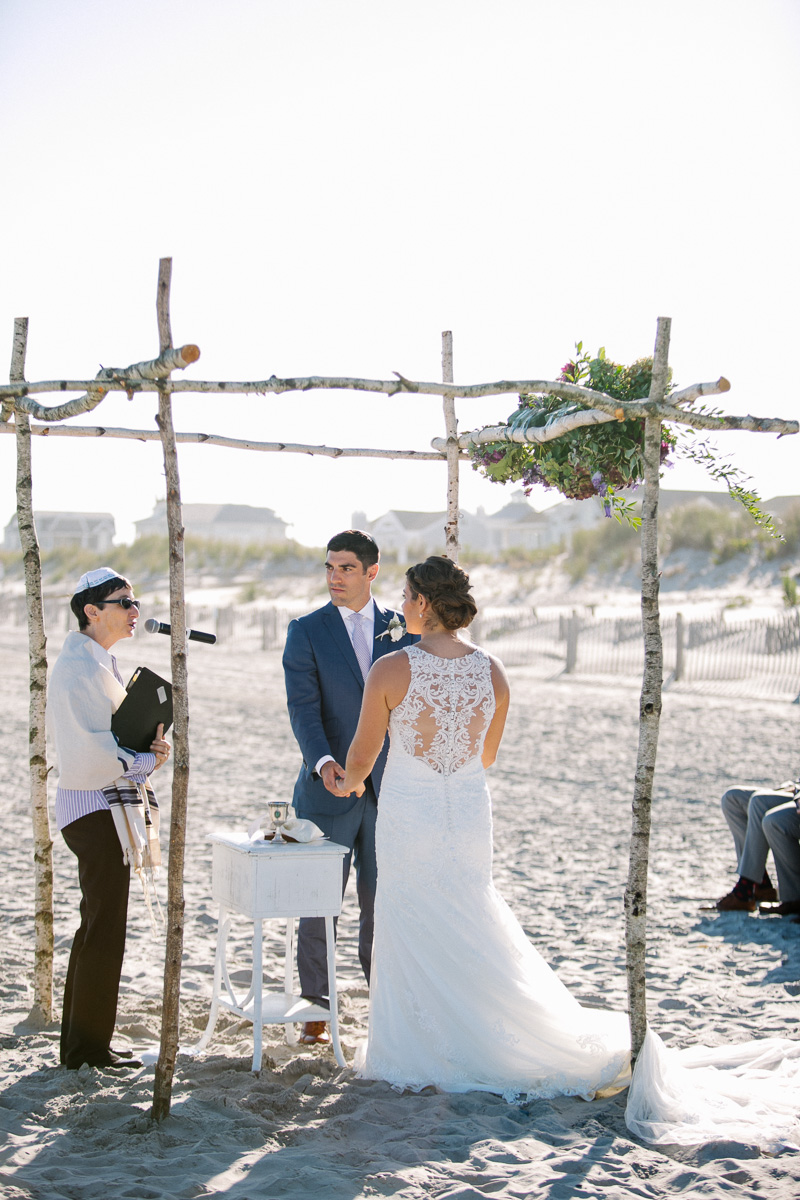 Outdoor NJ shore wedding complete with twig and floral chuppah.