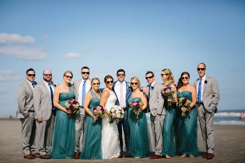 Unique portraits of the wedding party in turquoise before outdoor wedding ceremony.