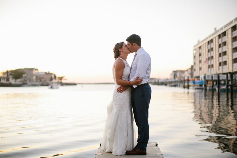 Bride and groom take portraits on the docks in New jersey.