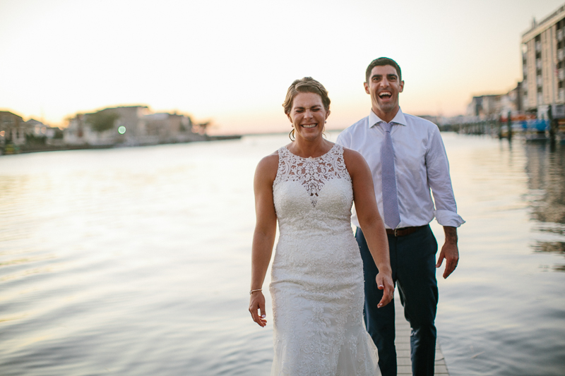 Bride and groom take portraits on the docks in New jersey.