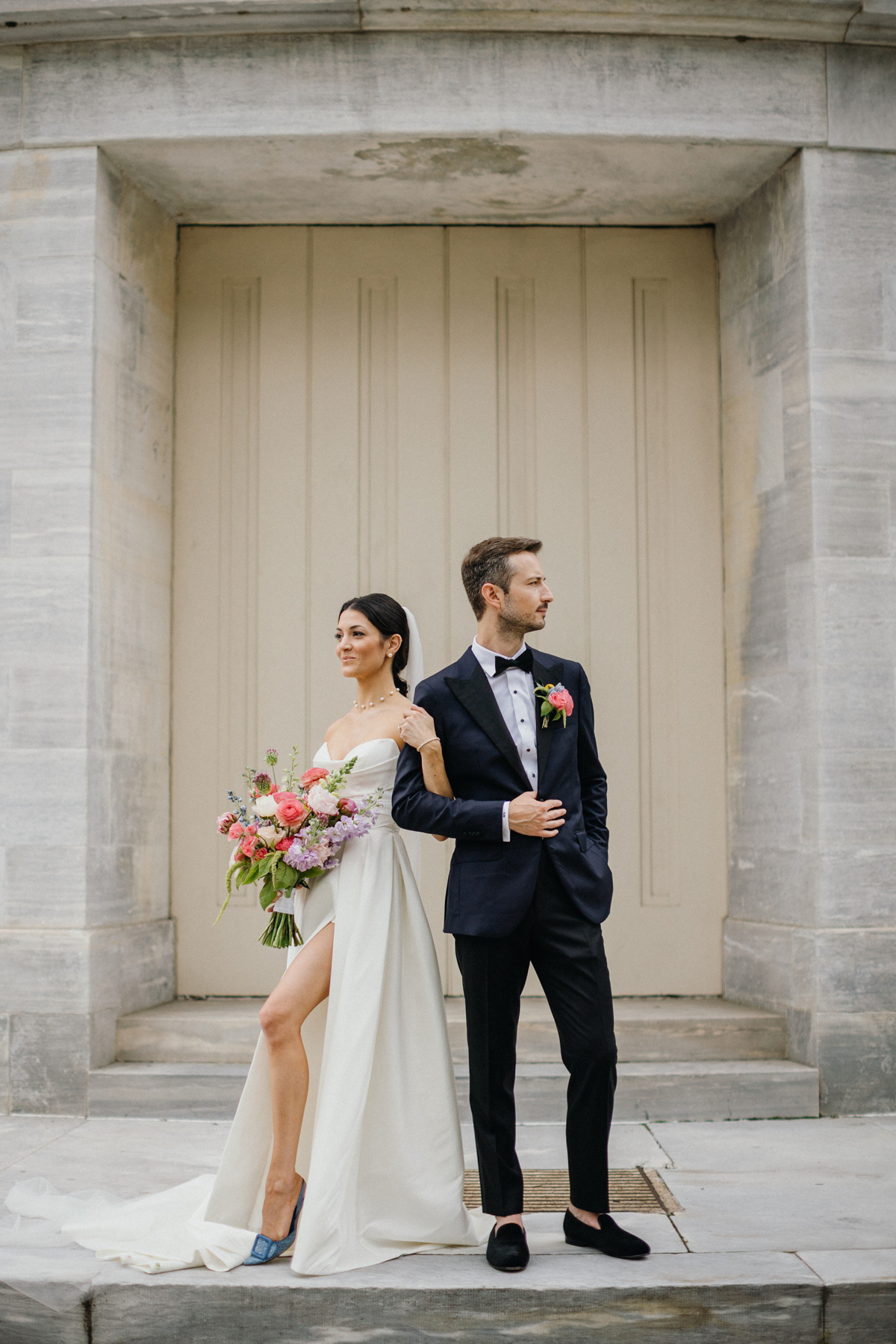 Modern and artsy portrait of wedding couple outside of the Merchant Exchange Building in Philly.