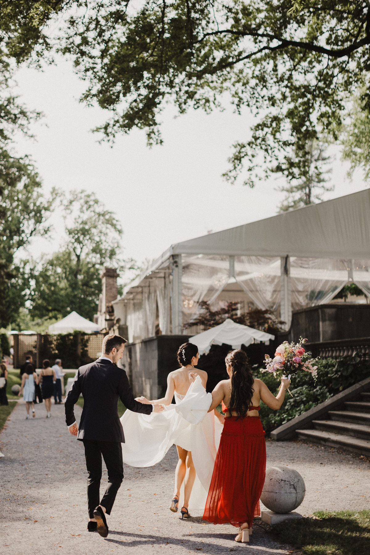 Candid photo of bride walking into her wedding reception thats taking place at Curtis Arboretum in Philadelphia, PA.