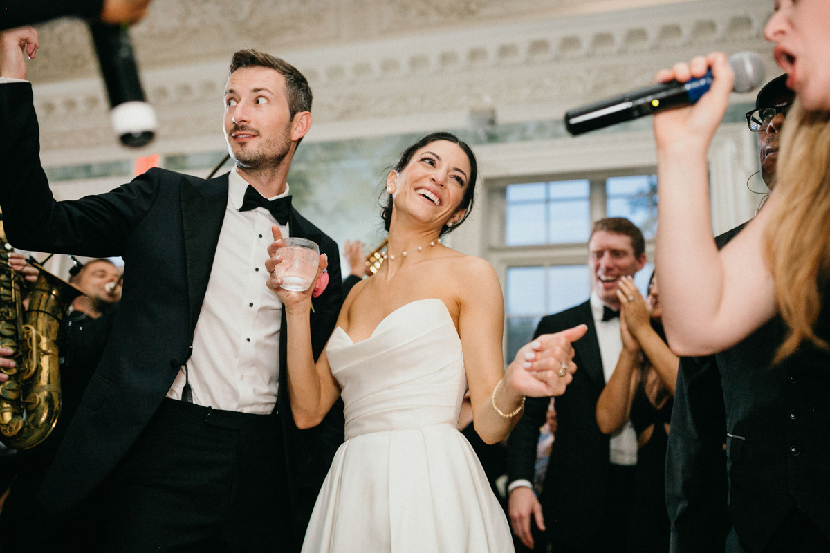 Candid of bride and groom at their wedding reception at their Curtis Arboretum wedding.