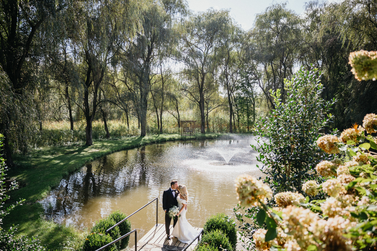 Garden wedding portraits in front of a fountain.