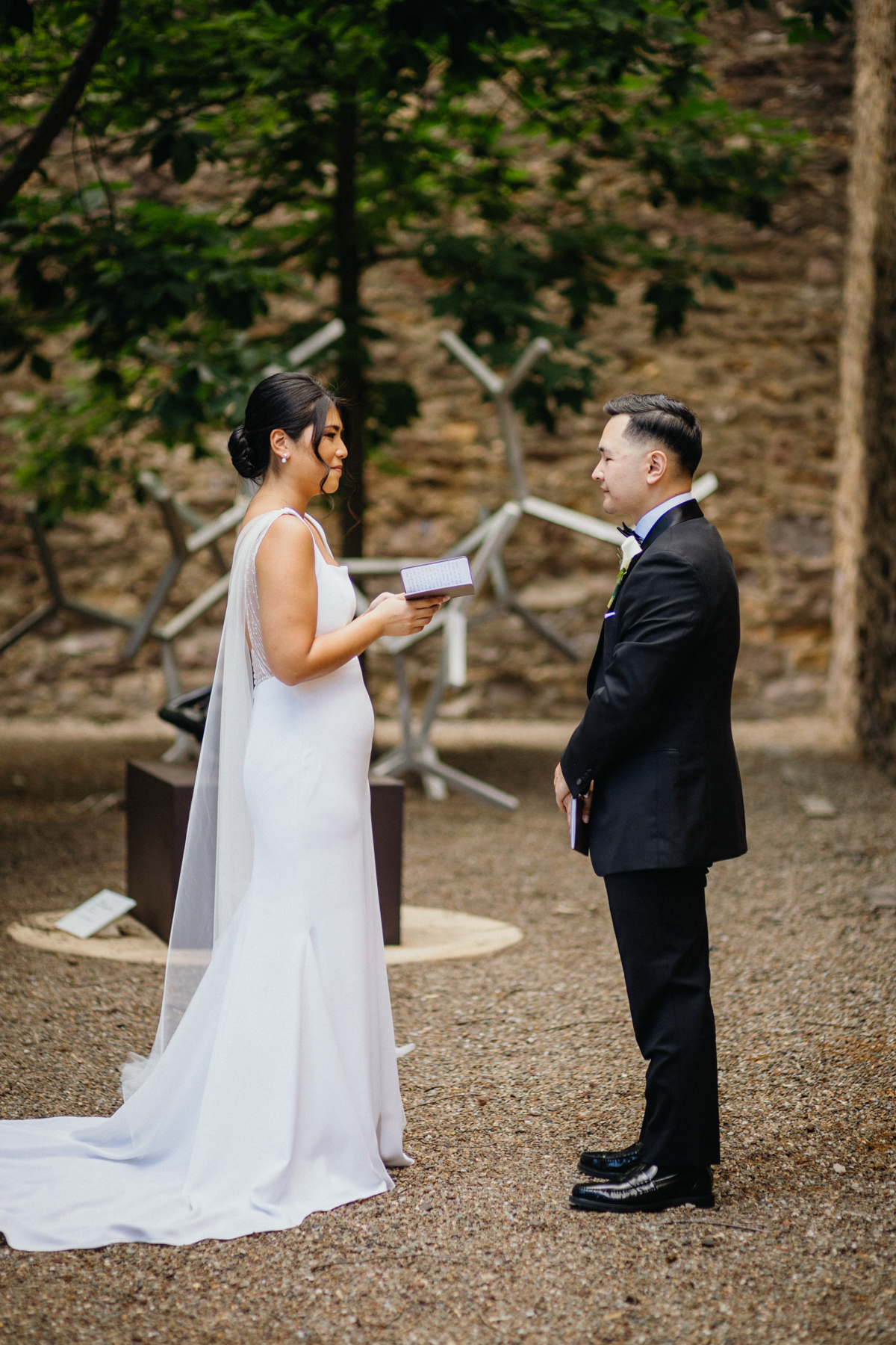 Bride and groom standing in courtyard garden at the Michener Museum as they privately read their vows to one another.