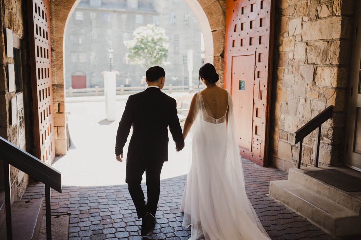 Candid photo shot from behind of couple walking through the Michener Museums grounds.