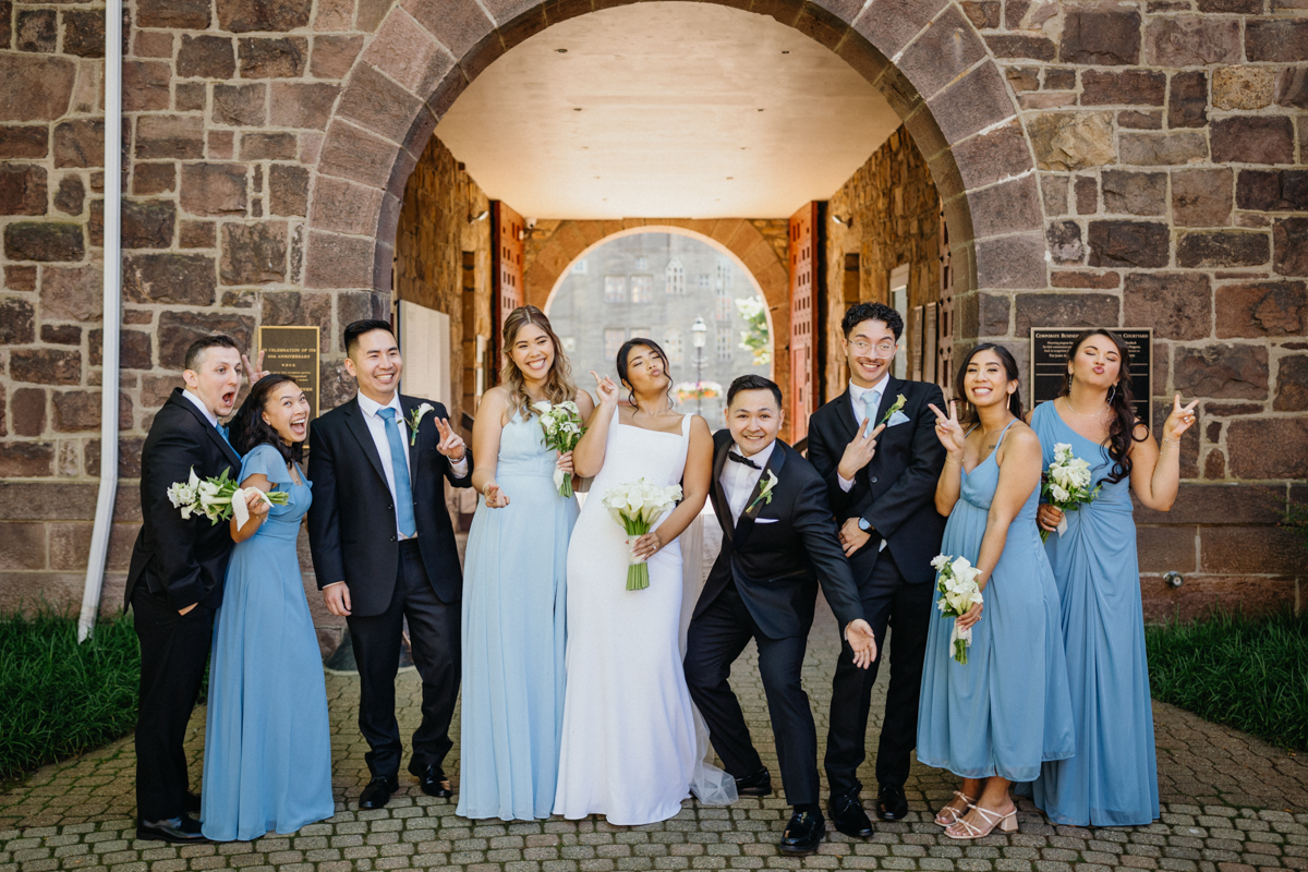 Bridal party portraits in front of an arch outside of the Michener Art Museum in Bucks County.