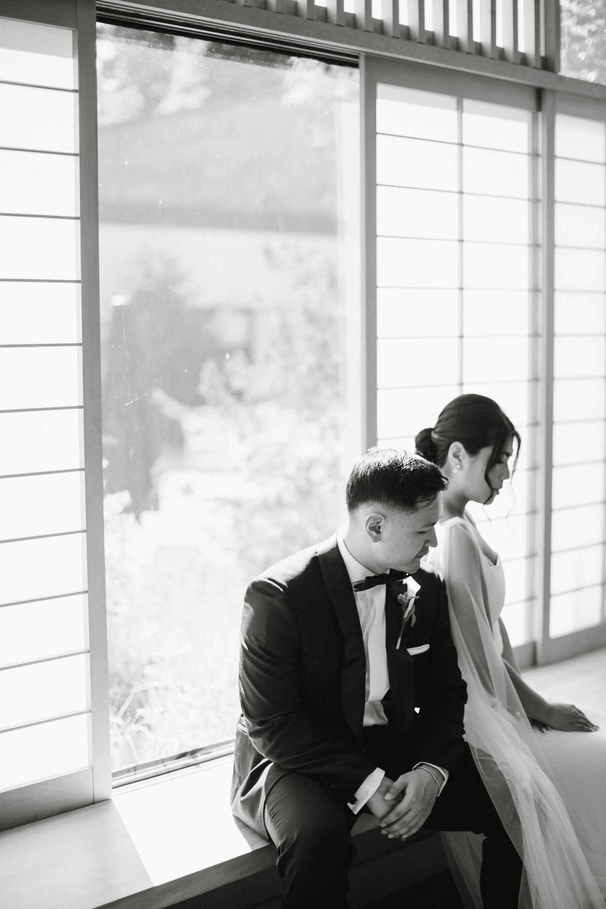 Editorial black and white portrait of a wedding couple in the Nakashima reading room at the Michener Art Museum.