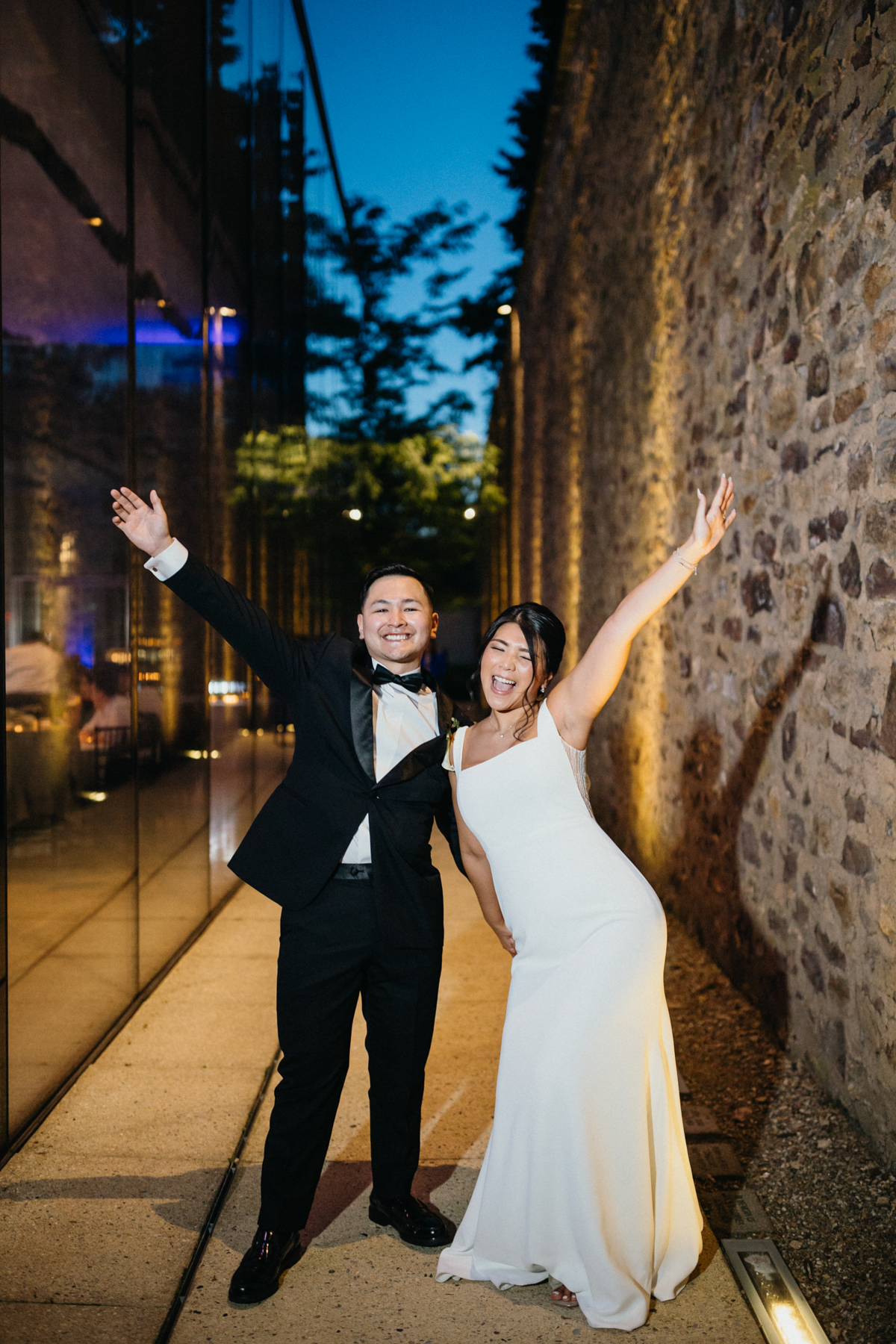 Bride and groom celebrating outside museum wedding reception.