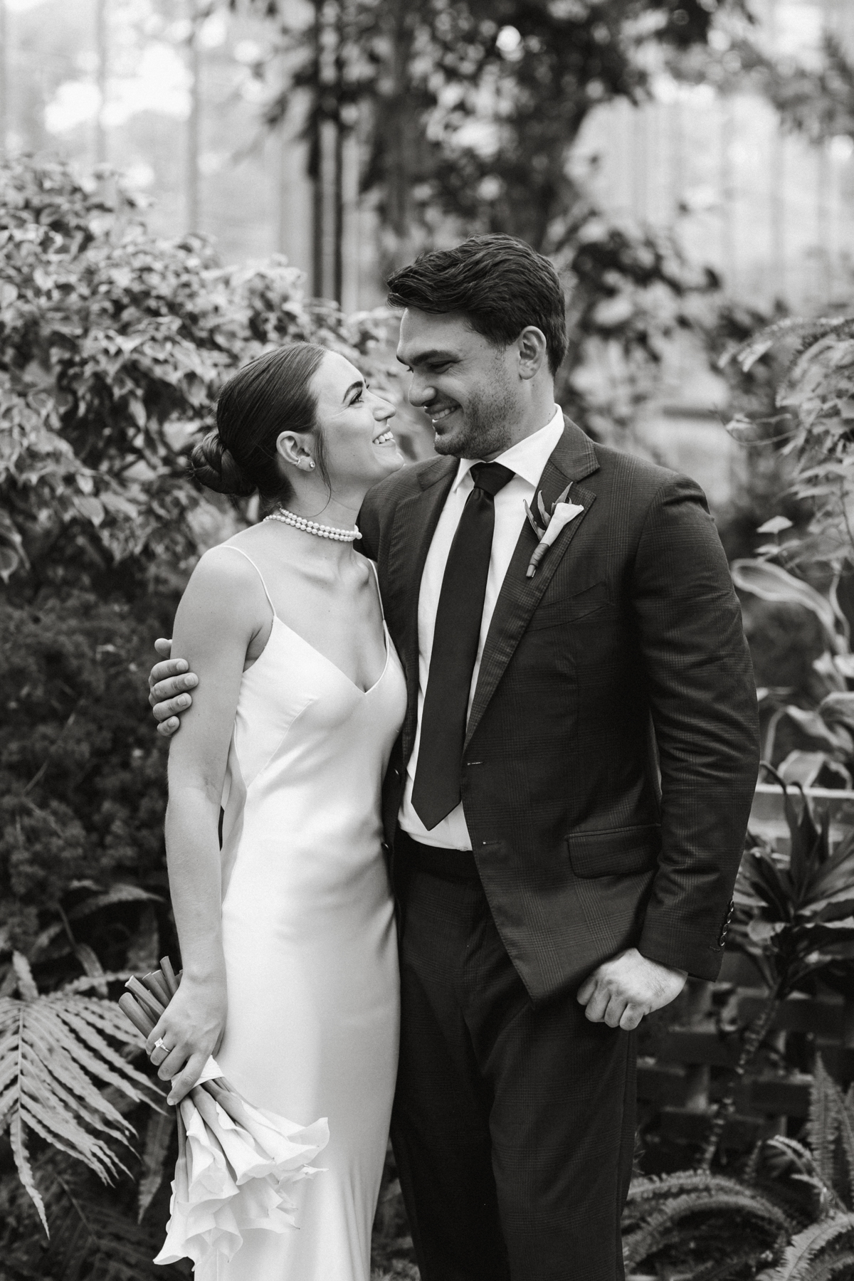 Black and white of couple smiling at each other.