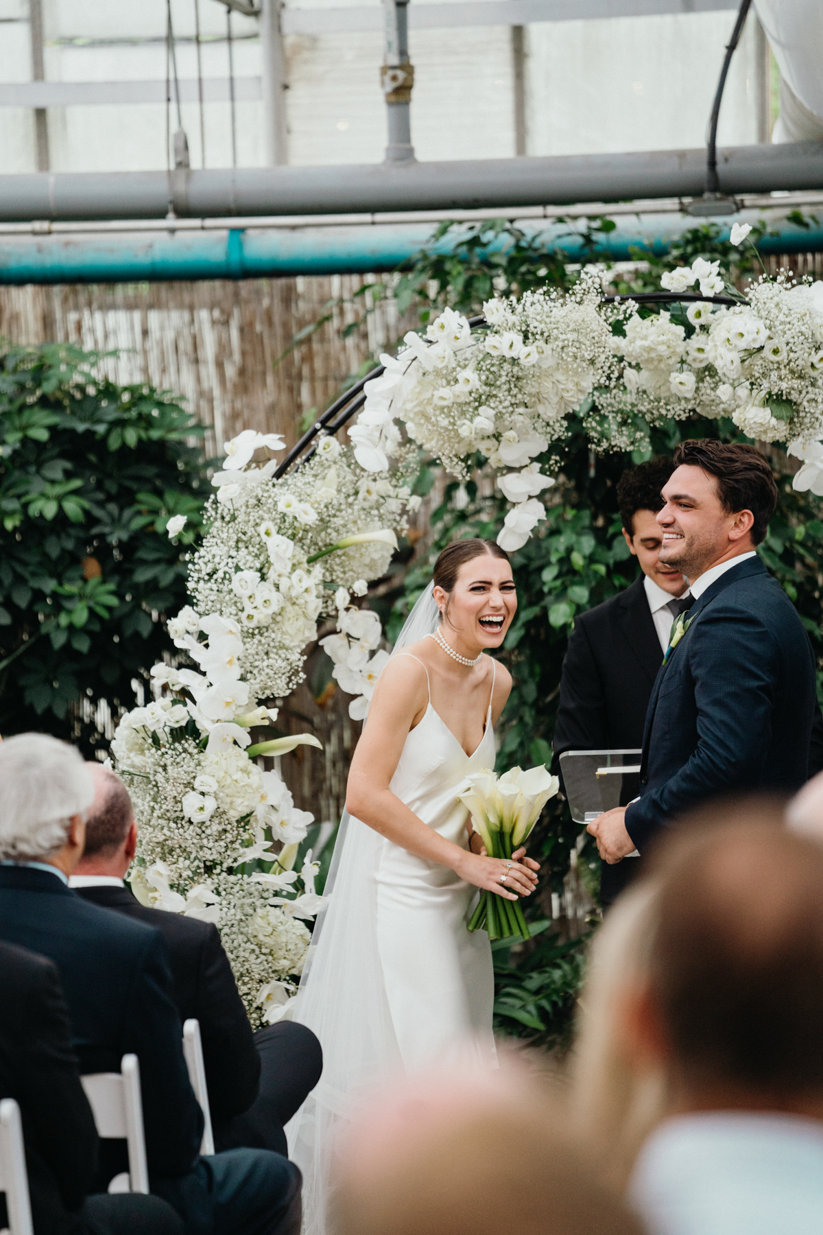 Wedding couple laughing at their ceremony.