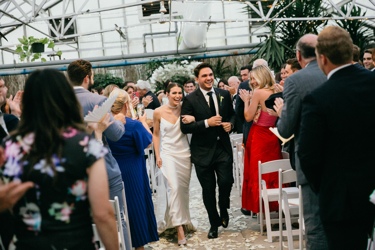 Couple celebrating as they walk down the aisle.