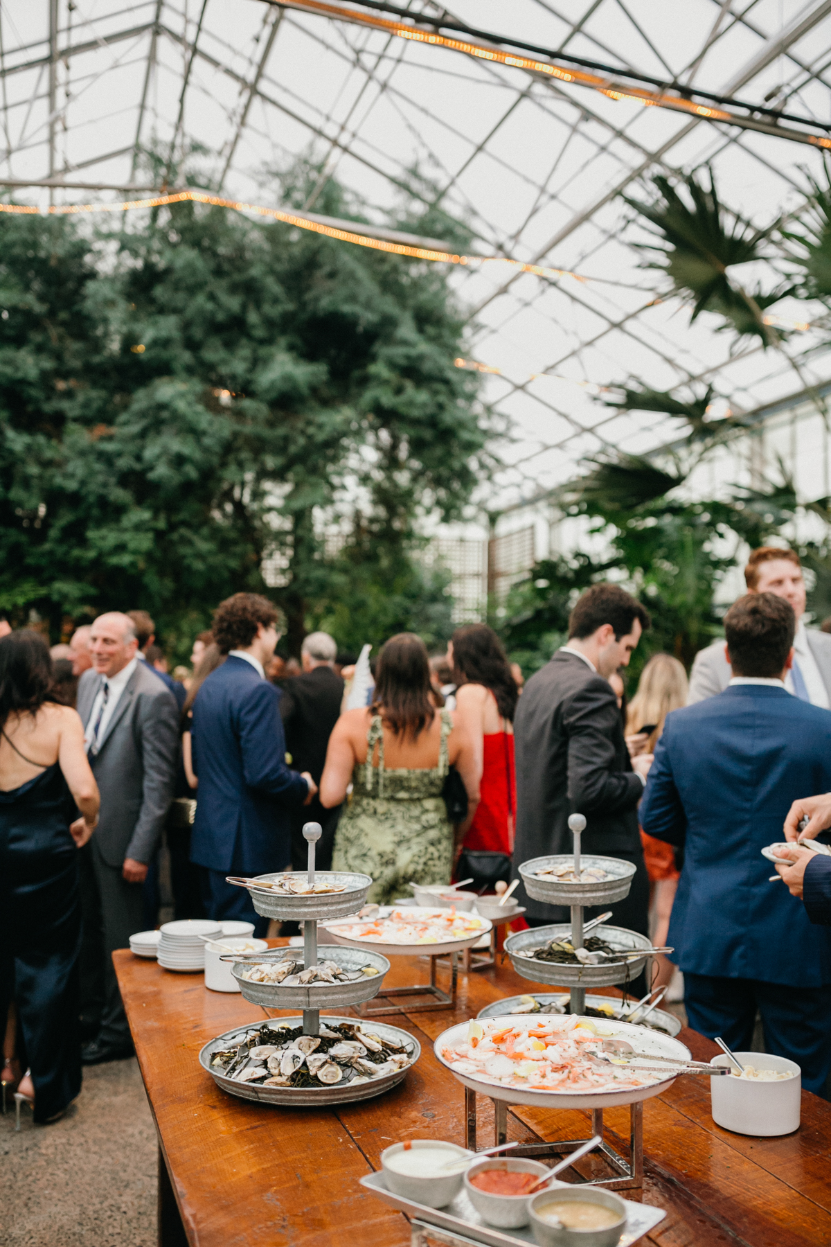 Cocktail hour in a large open greenhouse.