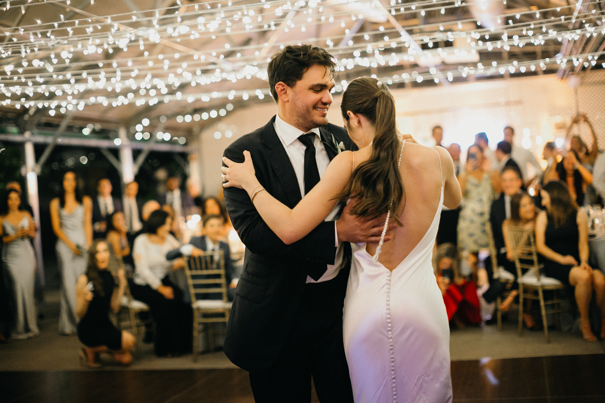 Bride and groom twisting as they dance together during their wedding reception.