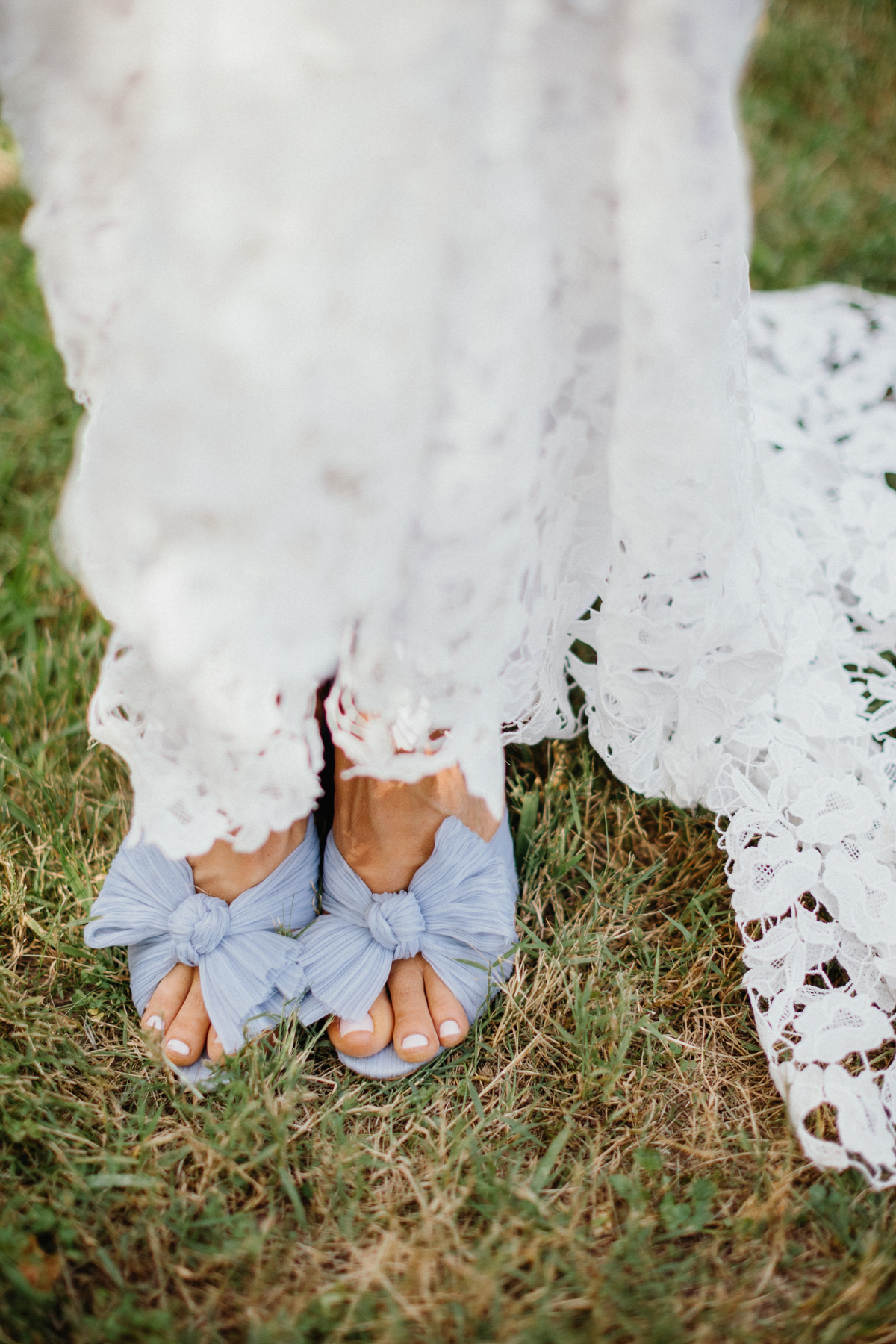 Lace bridal dress with light blue heels. 