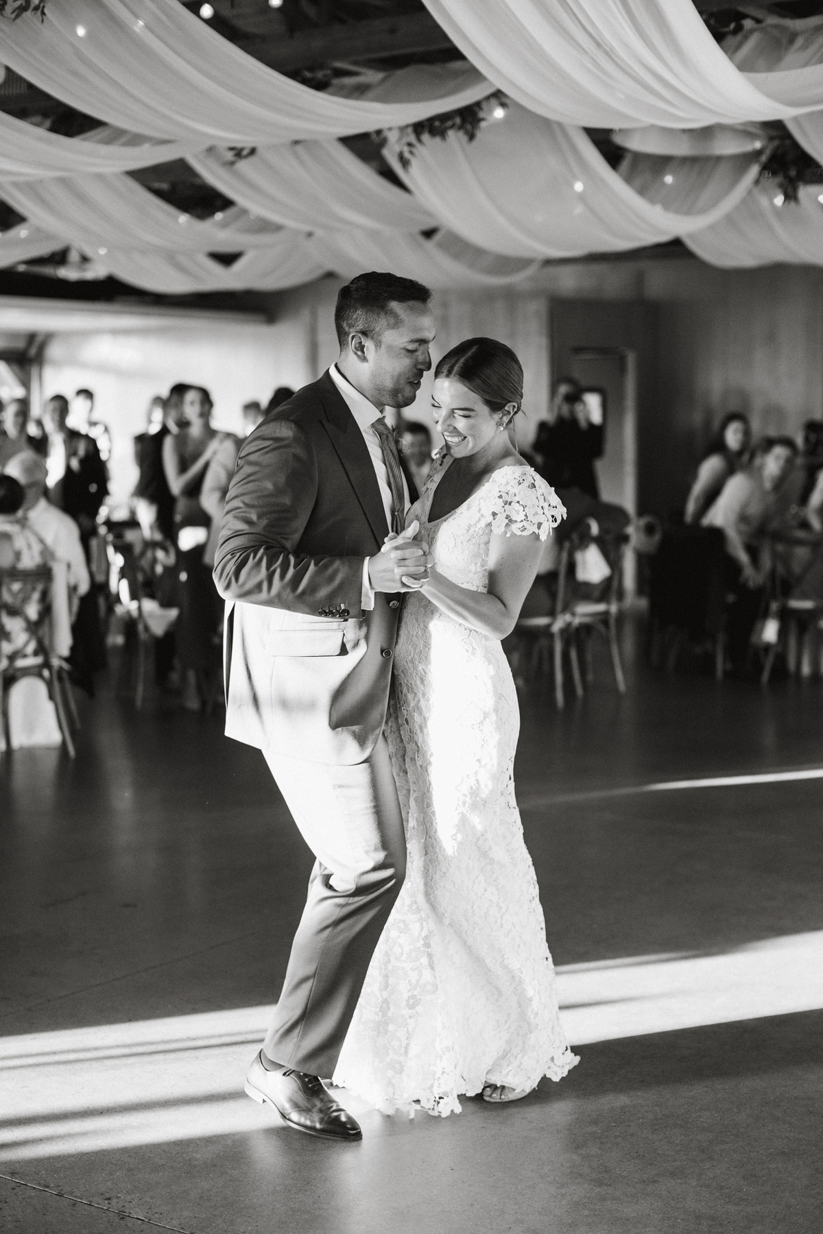 Black and white candid of Toni and Ben during their first dance.