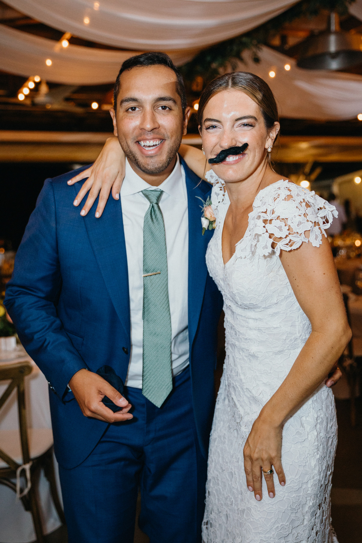 Bride and groom portrait with fake mustaches.