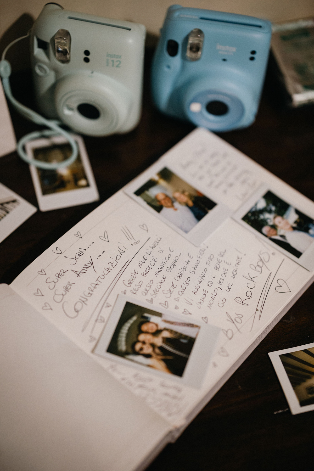 Guestbook featuring polaroids and handwritten notes at outdoor Philly wedding.