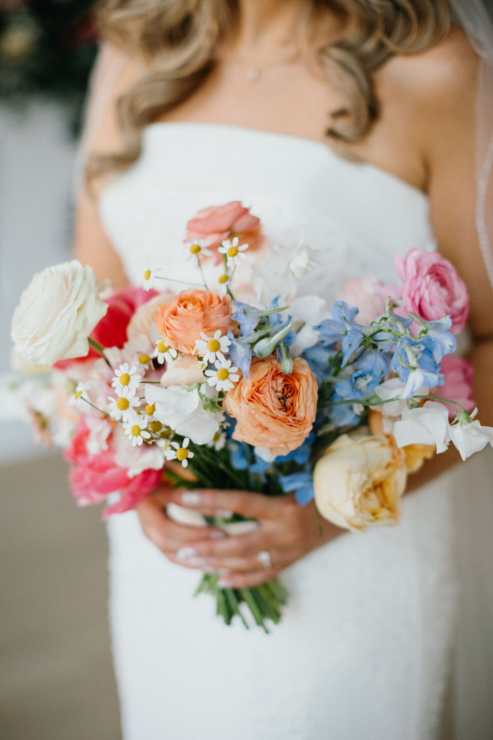 Colorful floral arrangements pop against the exposed brick backdrop.