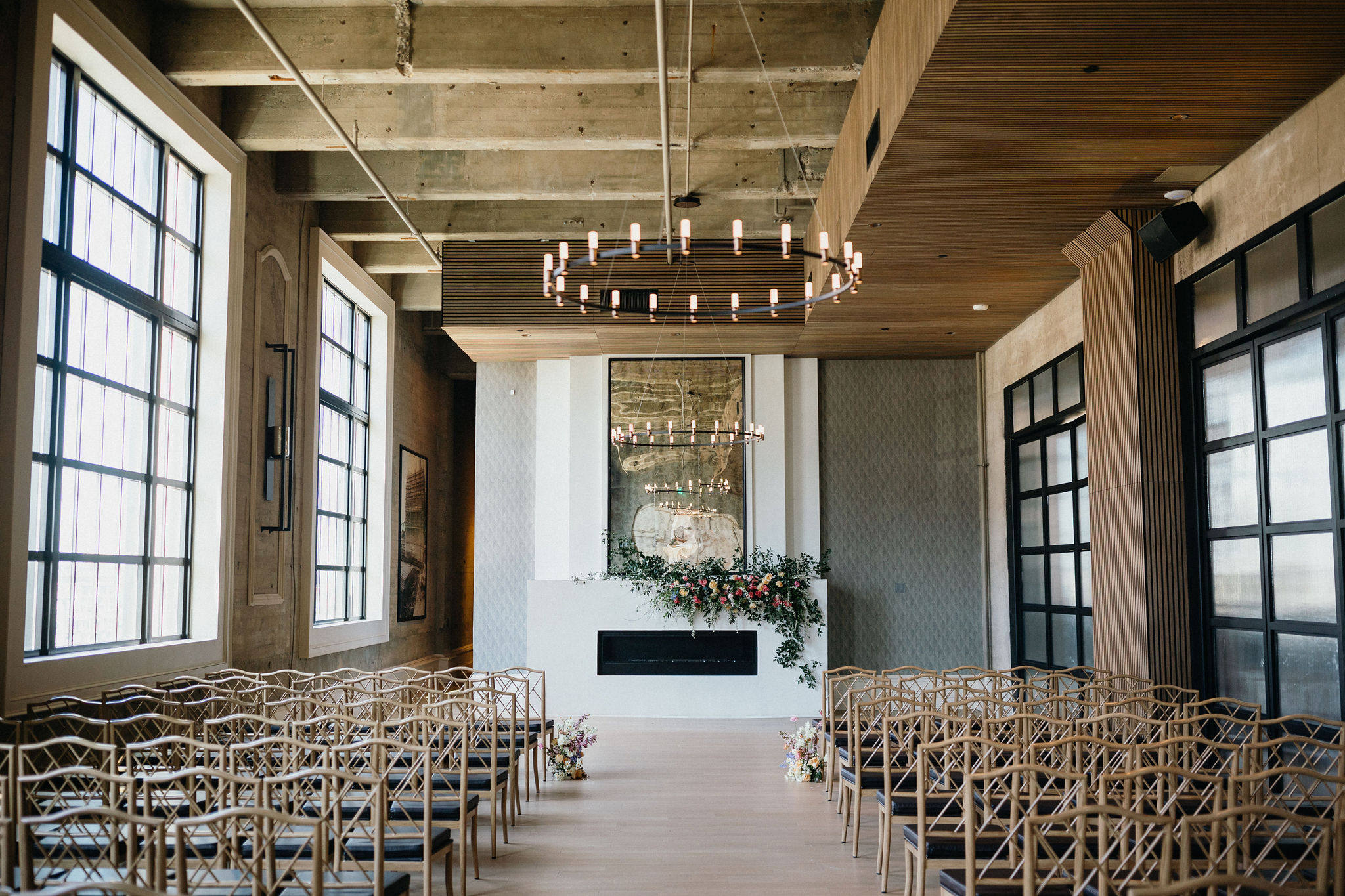 A floral-adorned ceremony space blends modern and romantic elements.