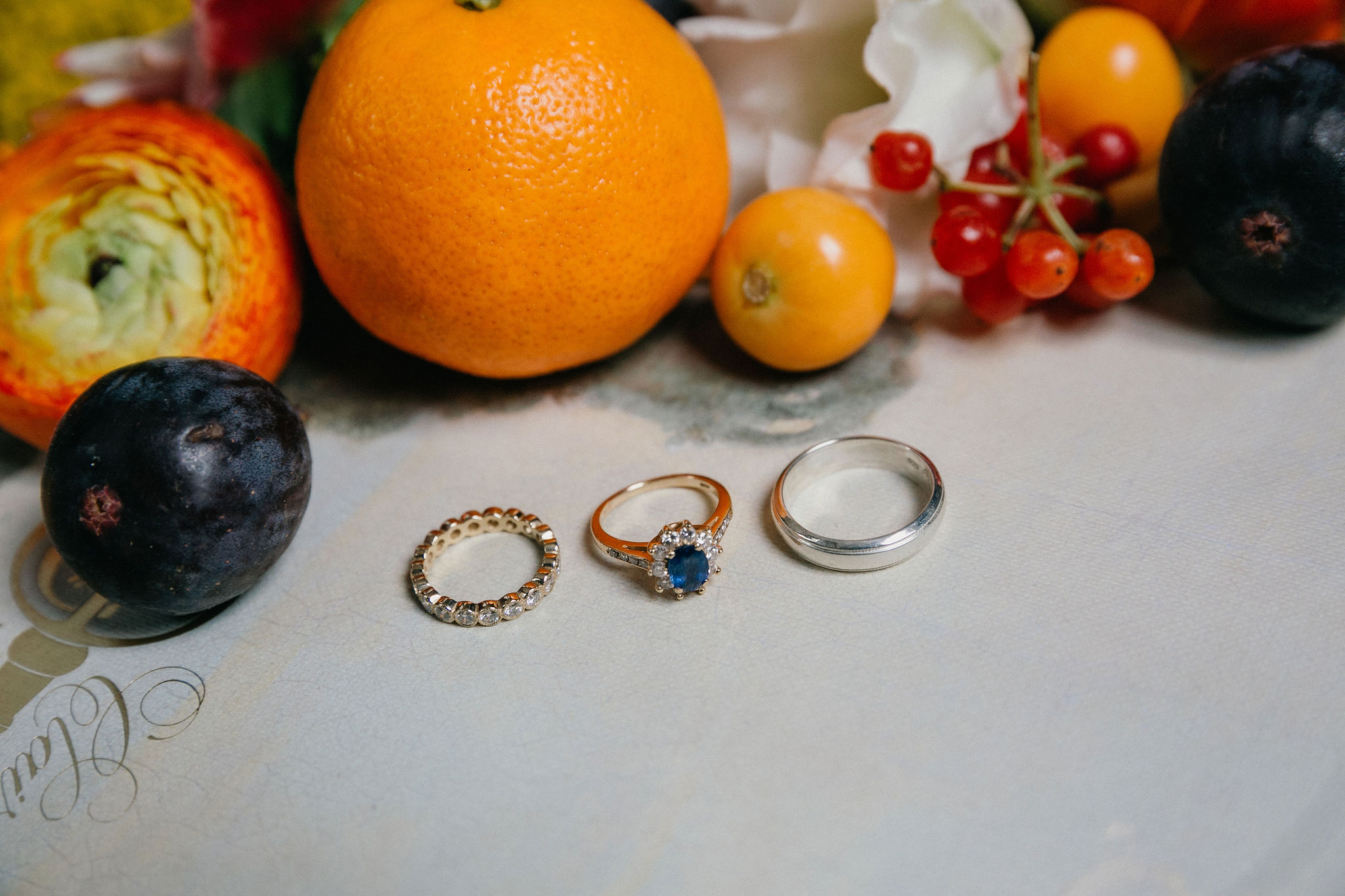 Blue engagement ring with oranges and blue invitation suite.