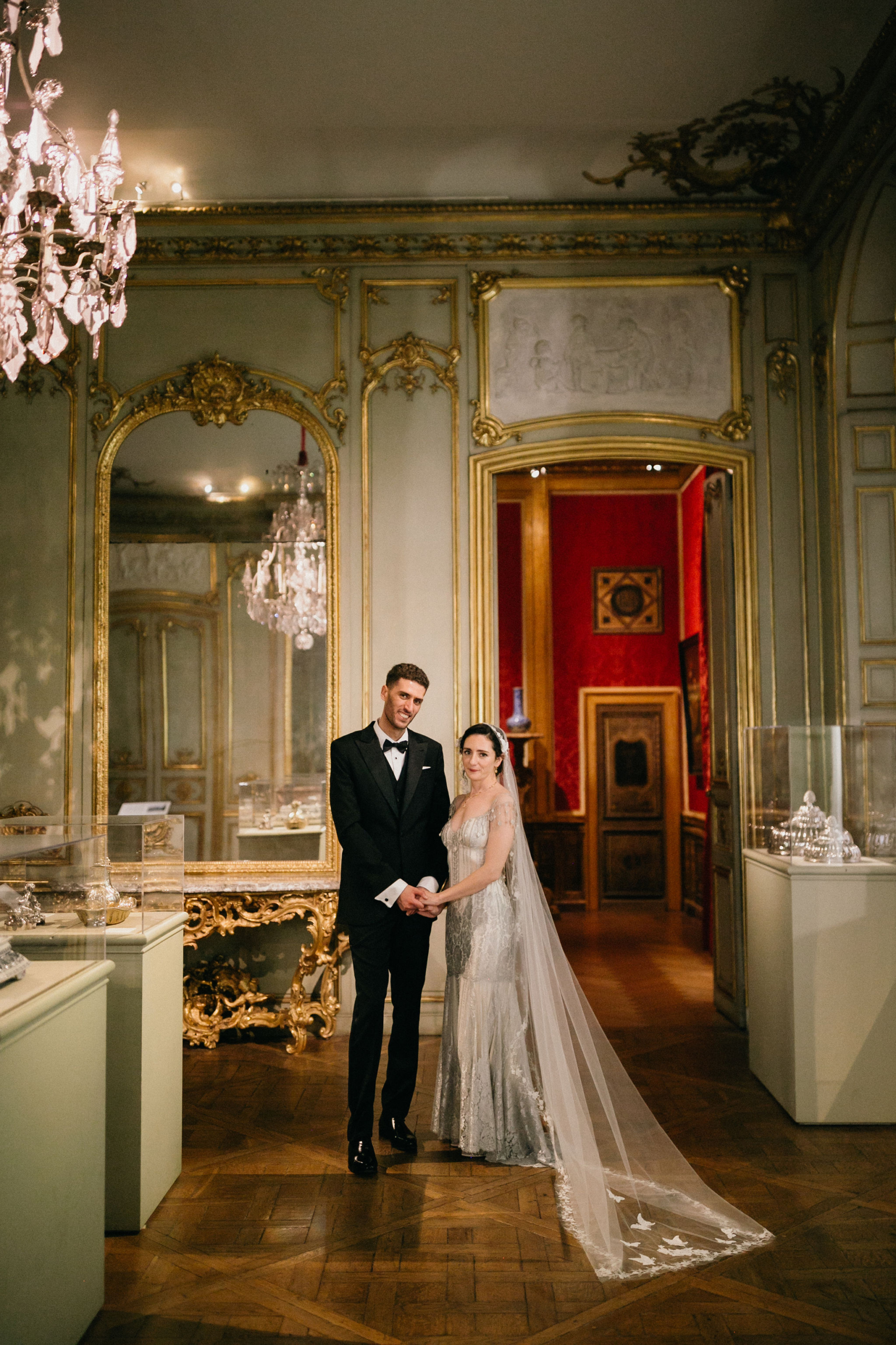 A wedding couple poses in an iconic museum setting in Philadelphia.