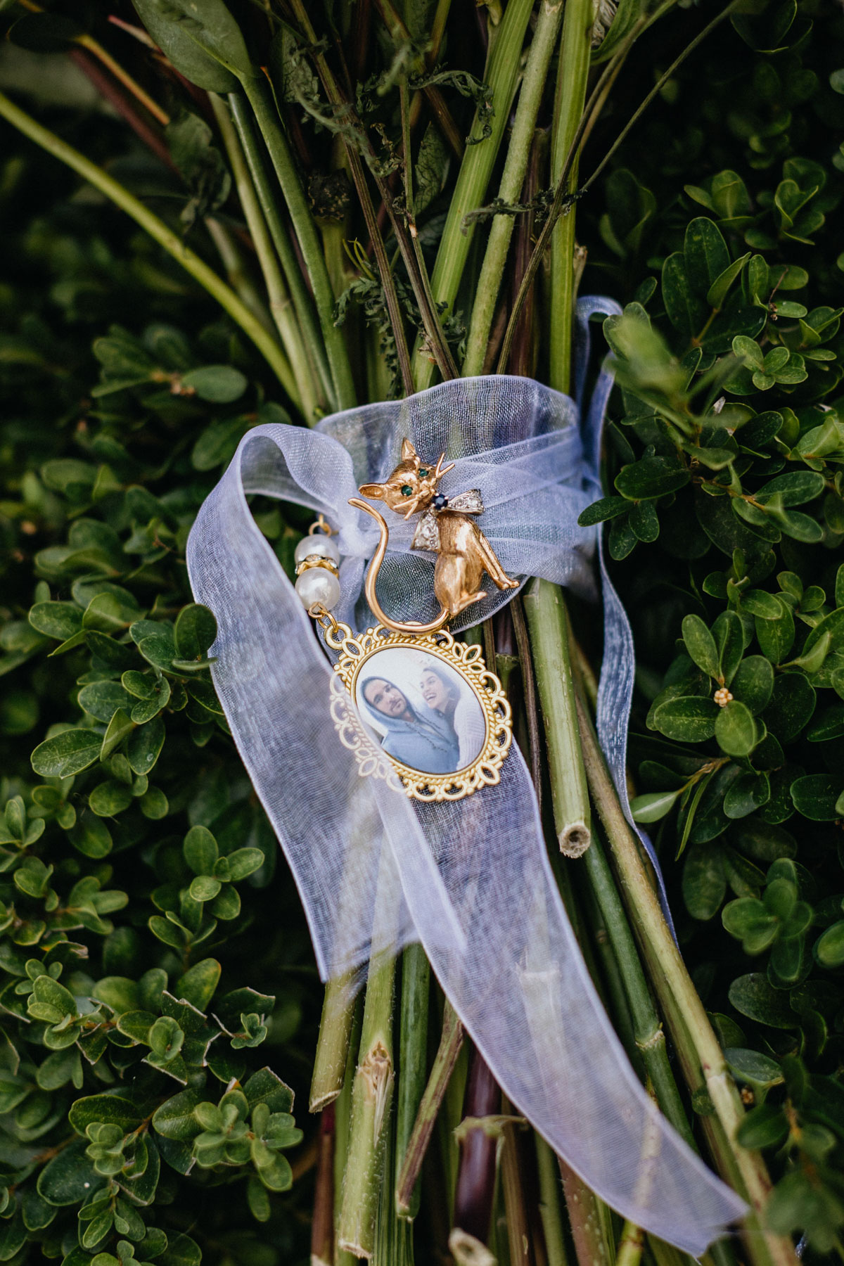 Charm on bouquet honoring bride's late family member.