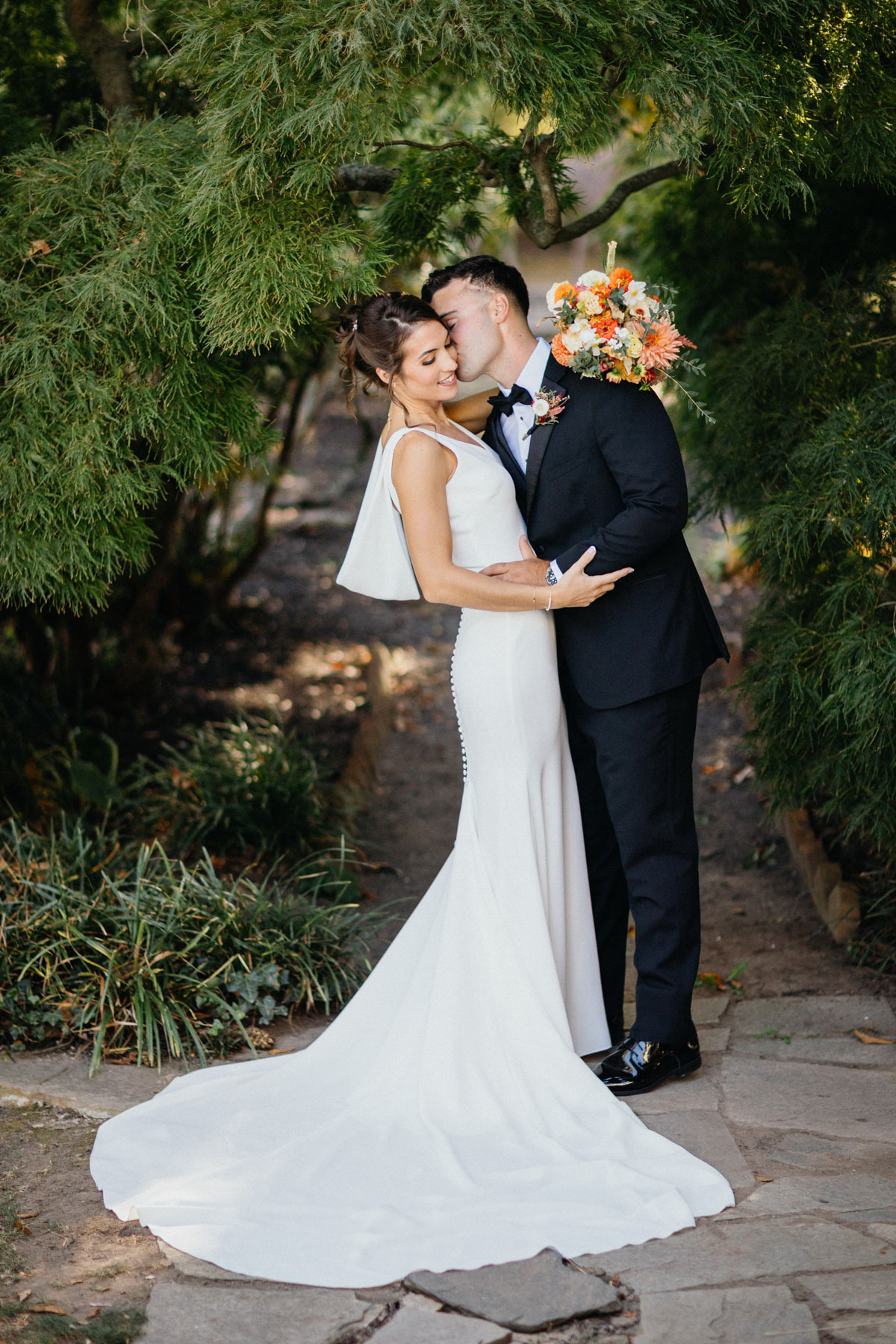 Bride and groom in Glen Foerd's gardens before their outdoor waterfront wedding ceremony.