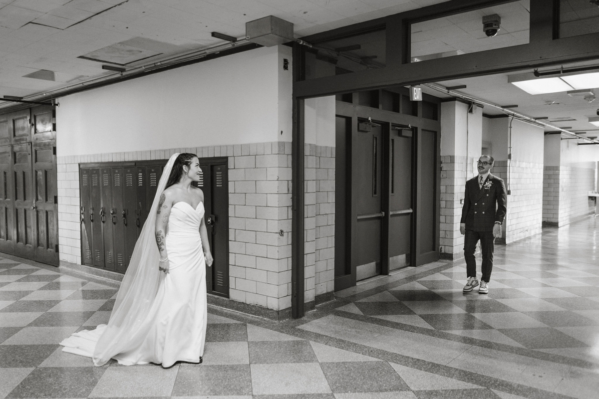 Bride and groom walking down a colorful hallway at Bok for their first look.