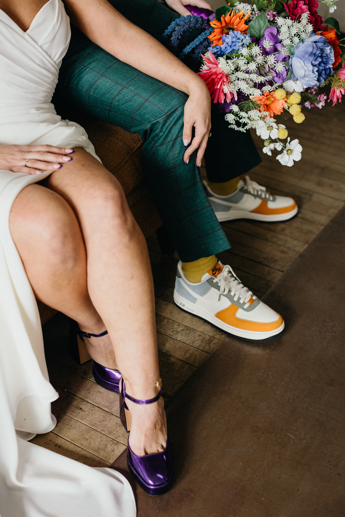 Artistic shot of funky and unique bride and grooms shoes and bouquet. 