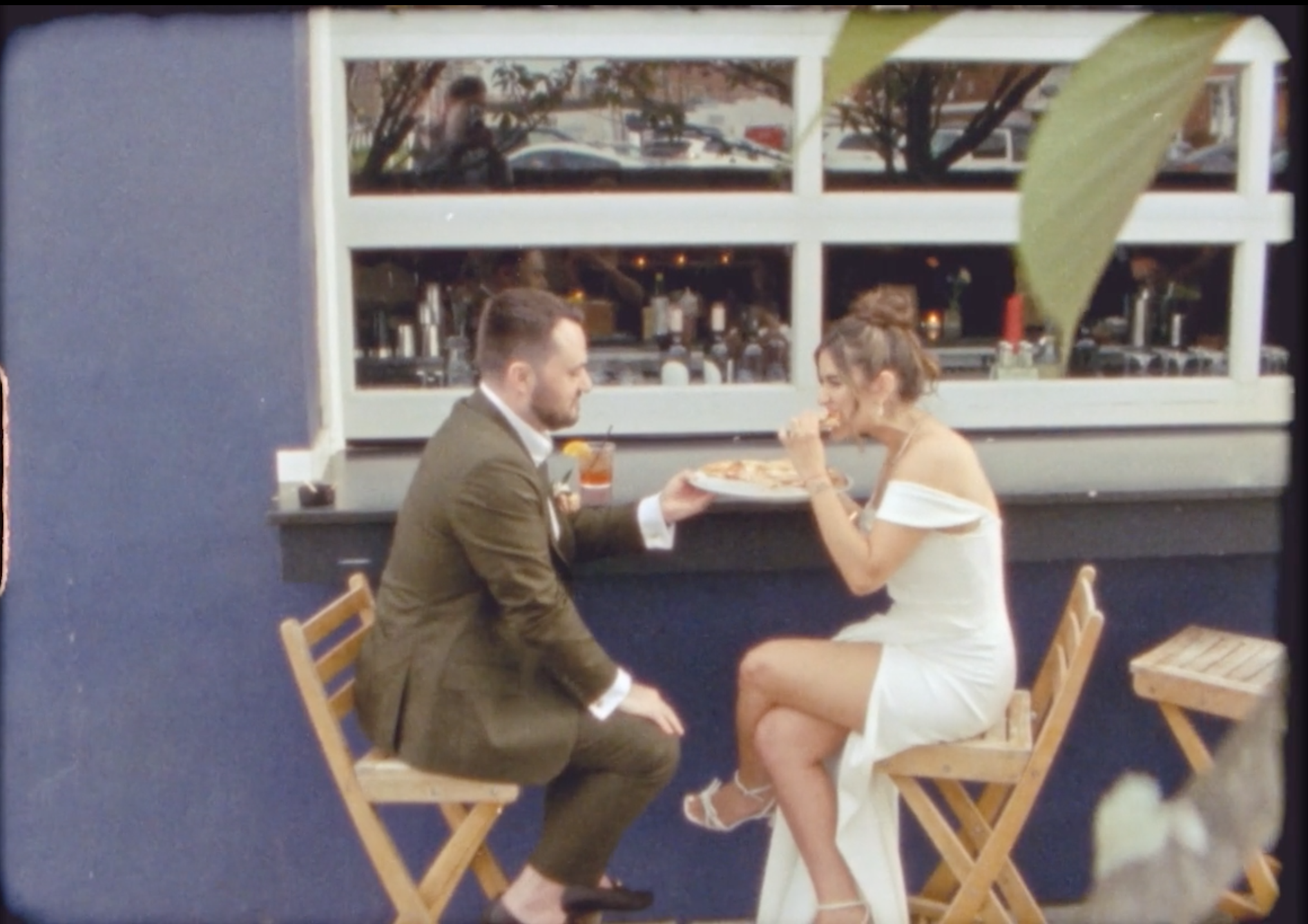 Candid moment of bride and groom eating pizza outside of Porta in Asbury Park.