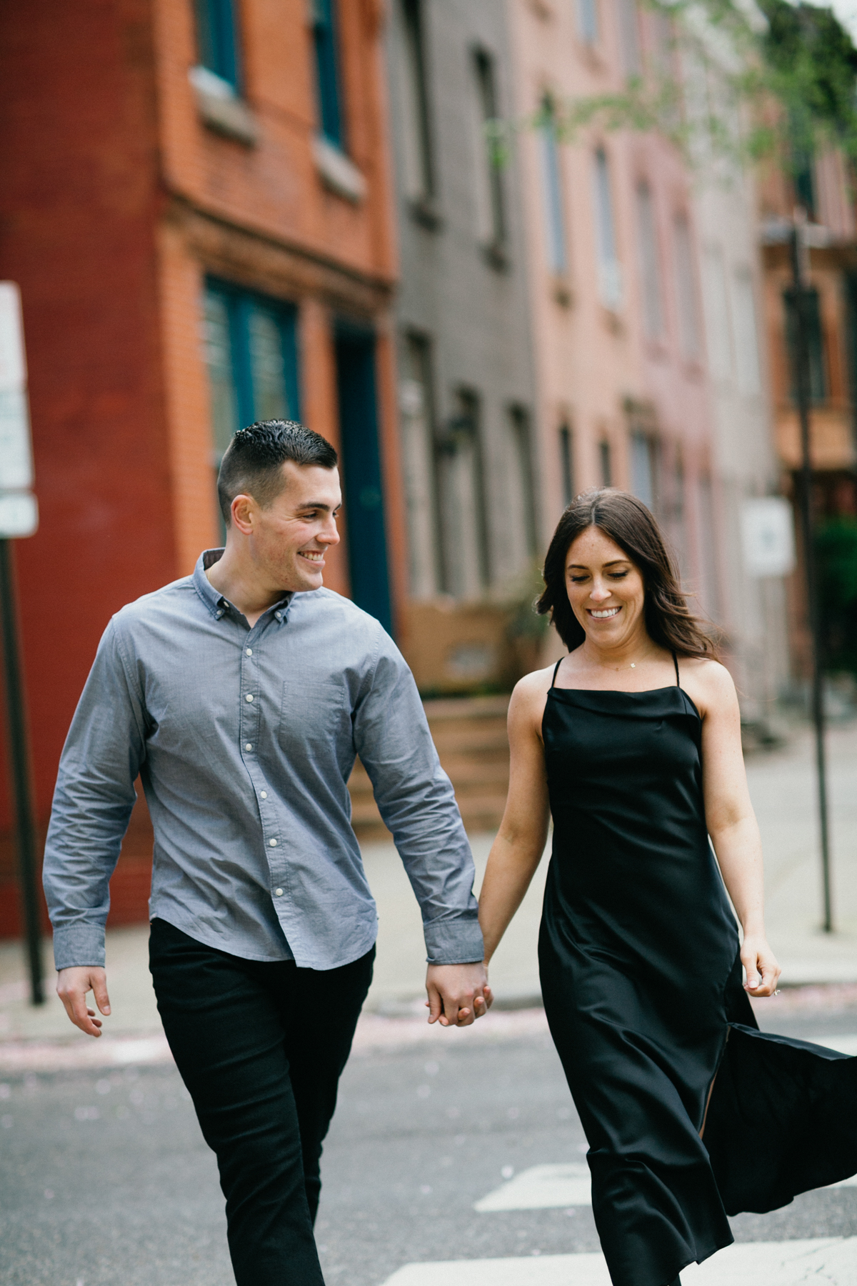 Couple walks hand in hand down a charming Philadelphia street during their engagement photos. 