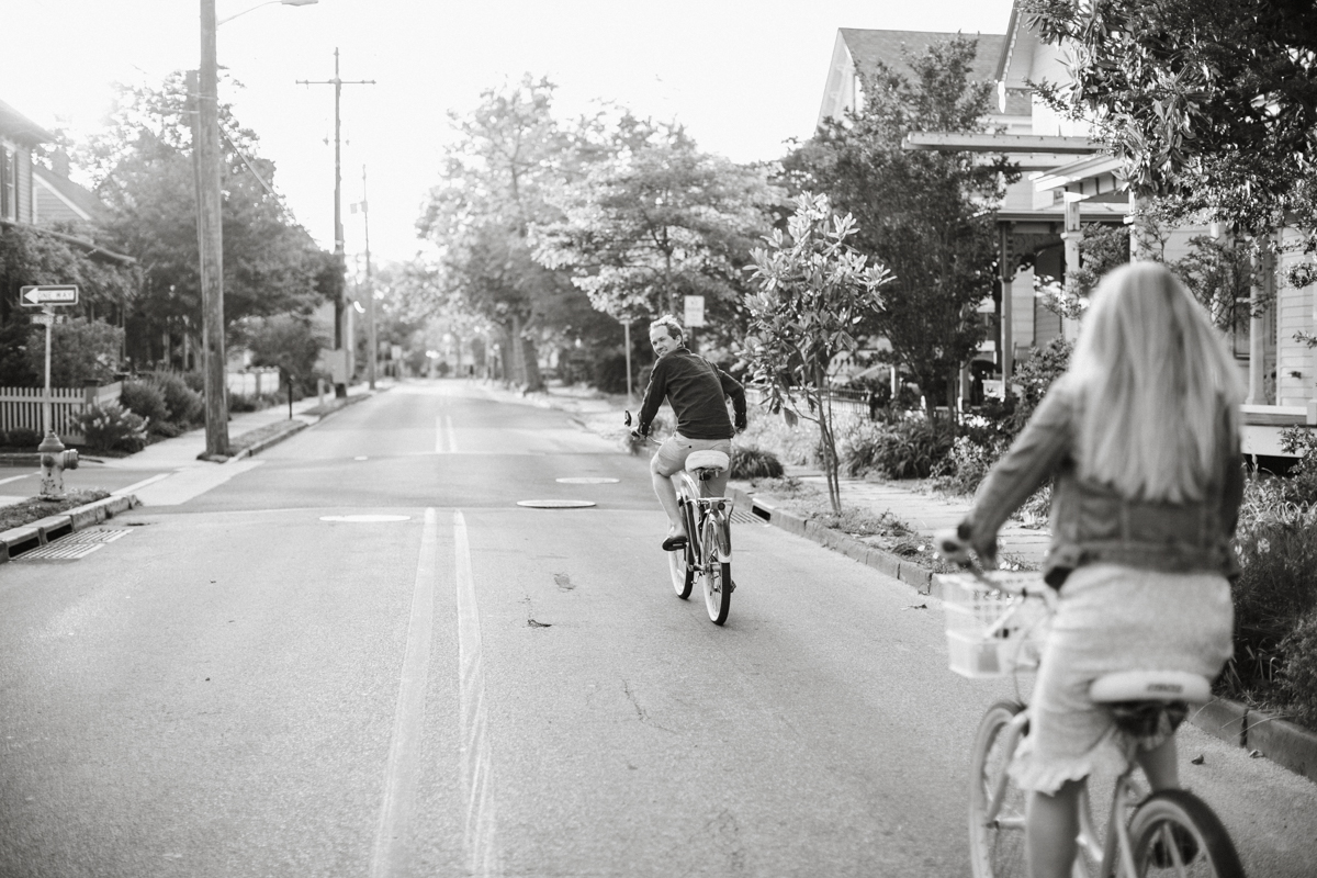 A couple shares a laugh while biking along the Cape May promenade, with the ocean breeze in their hair.