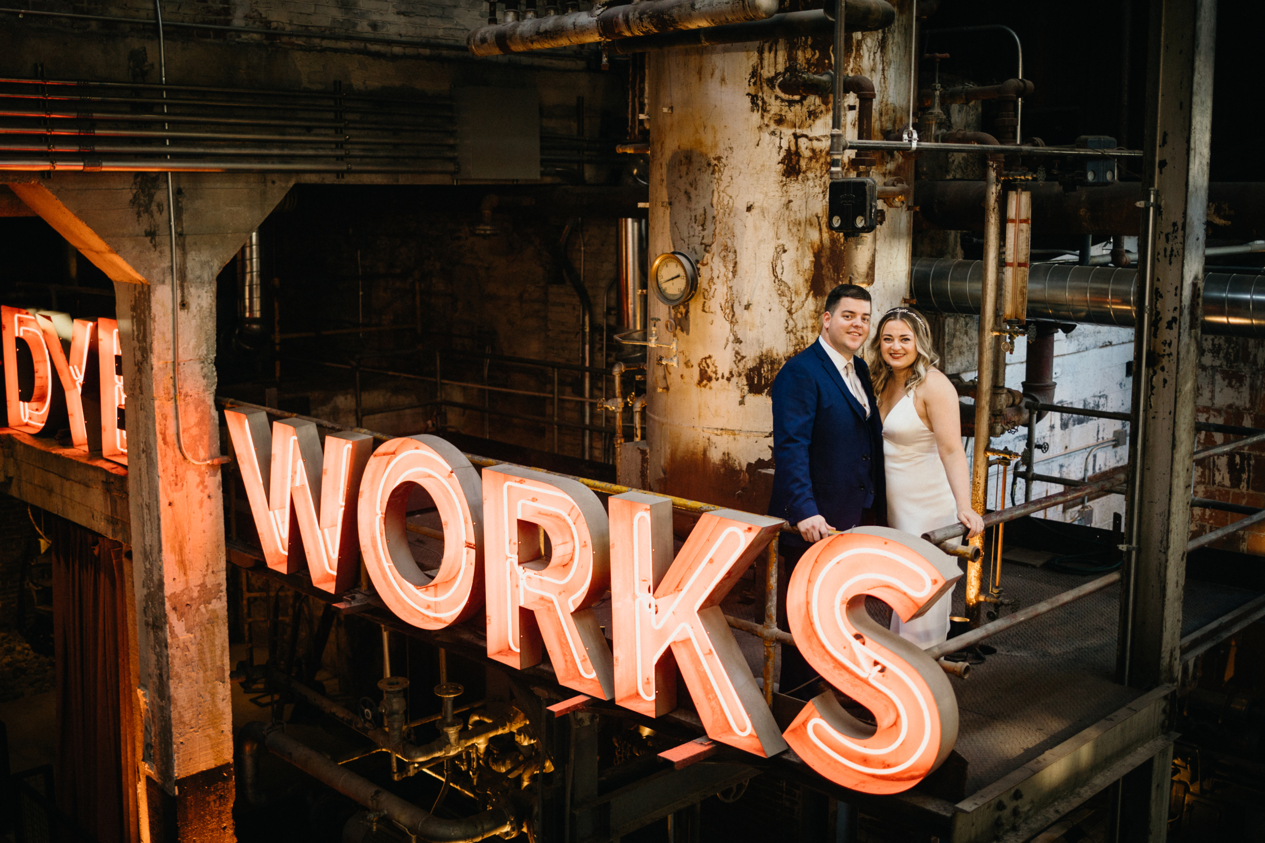 Fun wedding portrait in front of unique neon sign at wedding venue in Philly. 