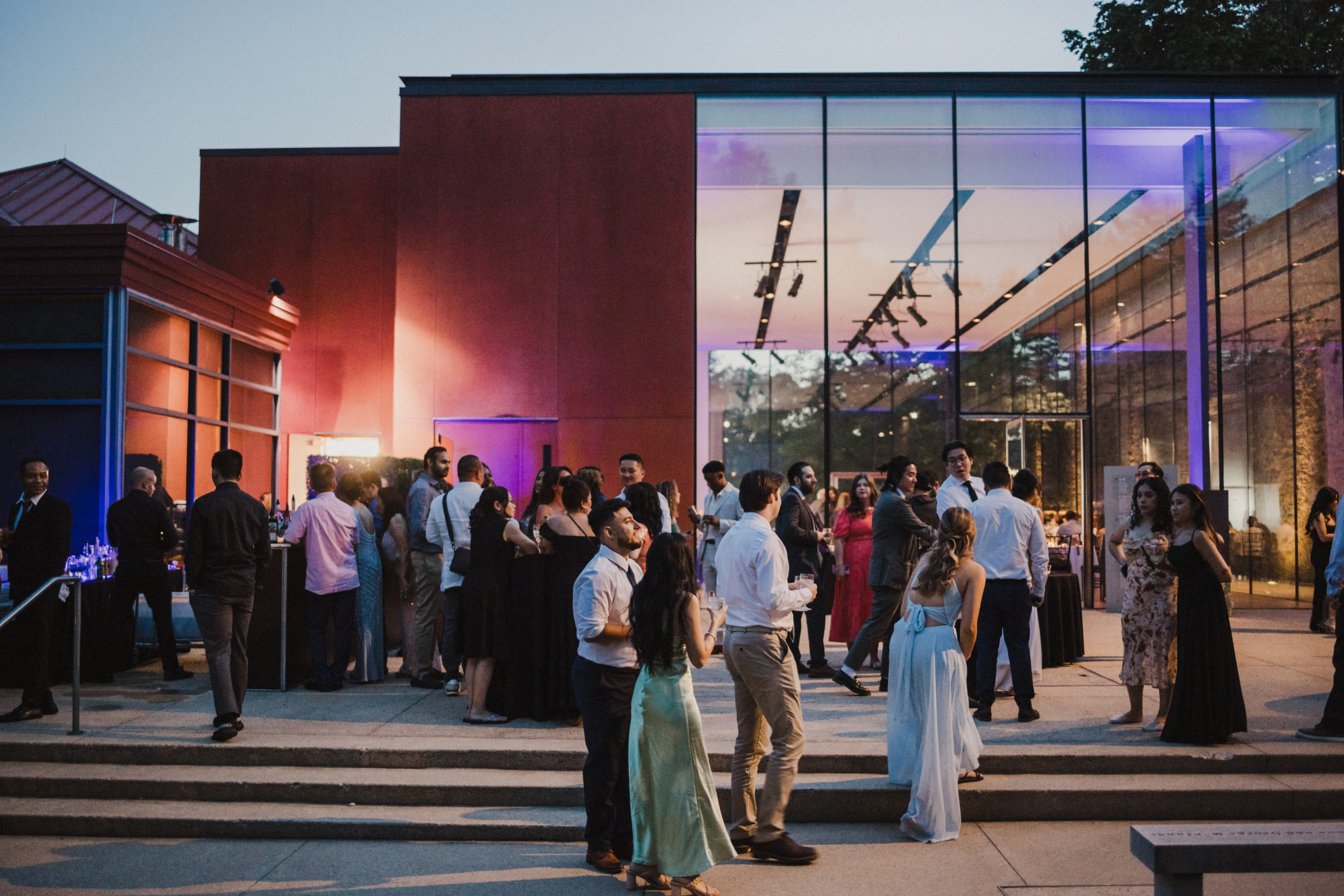 Champagne glasses clink in celebration as guests gather in the Michener Museum’s softly lit event space.