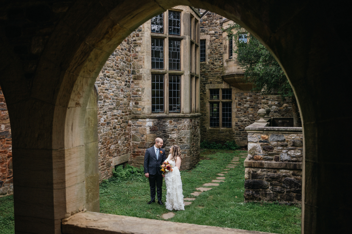 Estate wedding venue with a breathtaking arched entryway and sprawling green lawns.