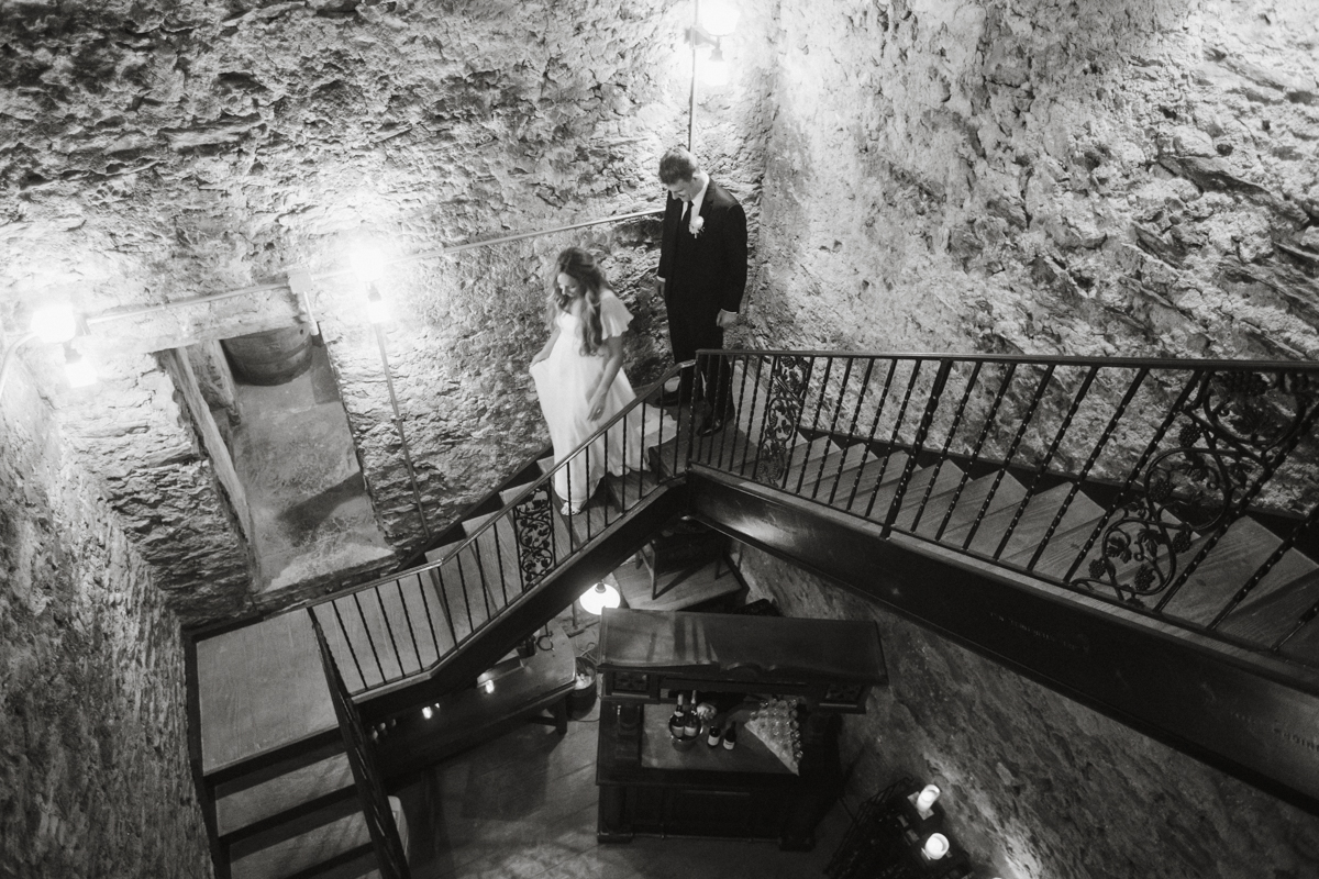 Bride and groom head down to the wine cellar during their reception at Philadelphia estate wedding venue.