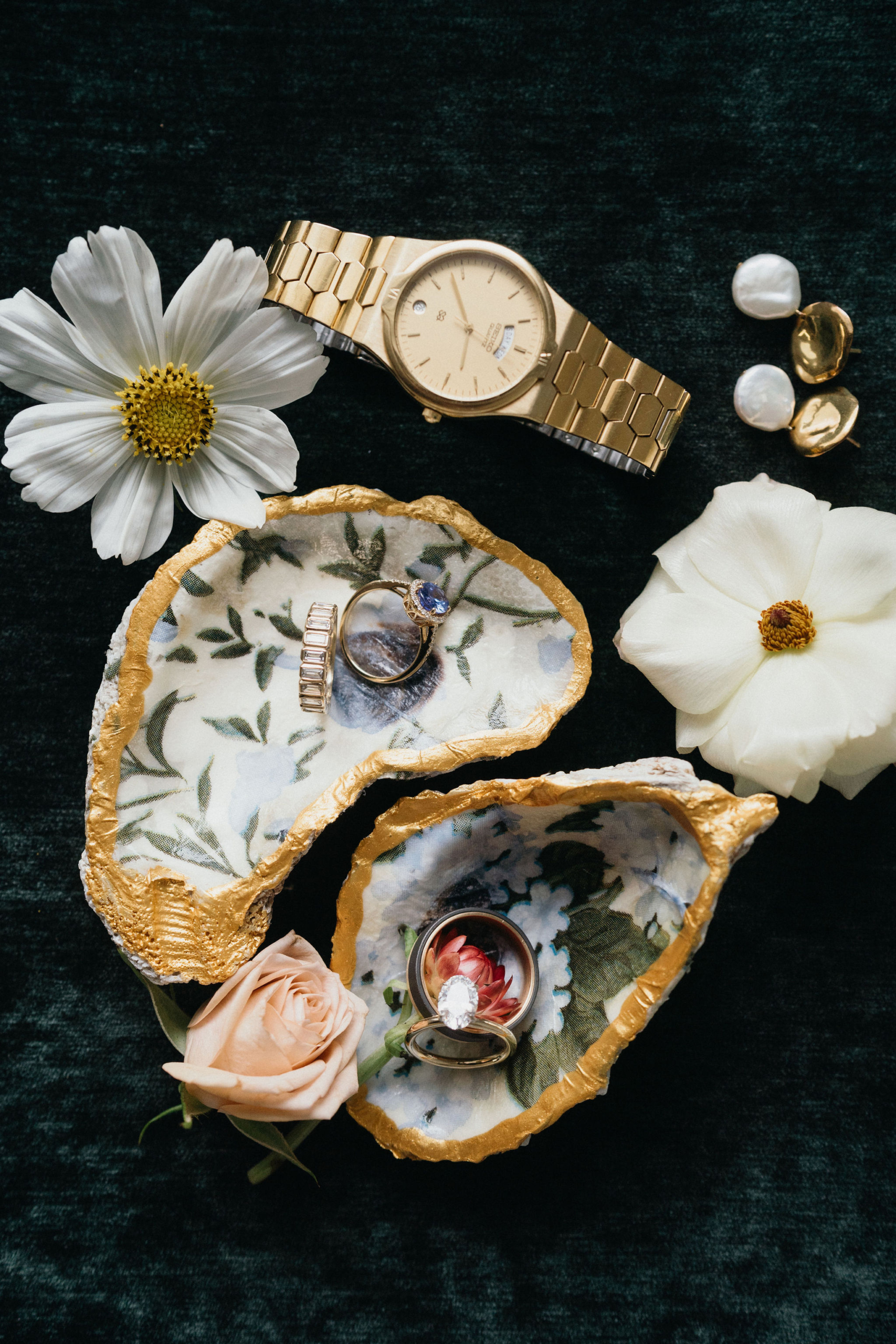 Flat lay of ring in oyster shell with hand painted interior.